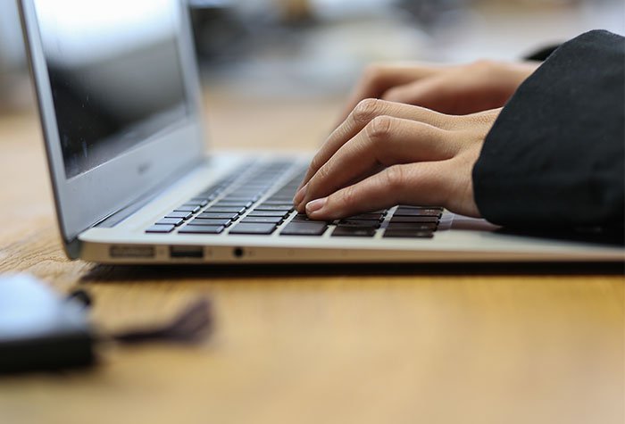 Typing on laptop